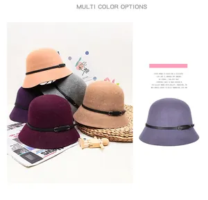 Detail view of wool felt cloche hats in various colors with decorative leather buckles
