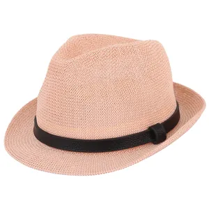 Detail of pink straw fedora hat featuring a woven texture and black leather decorative belt