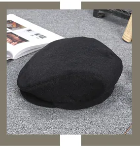 Detailed close-up of premium black cashmere newsboy cap fabric with soft fuzzy texture