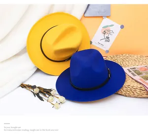 Detail of wool fedora hats in yellow and navy with black leather bands and metal buckles