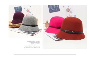 Detail view of winter wool cloche hats in purple and grey with leather buckle straps