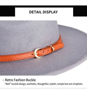 Macro detail of wool fedora with orange leather band and polished gold metal buckle