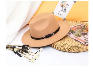 Detailed close-up of a camel wool fedora hat with a black band and silver metal buckle
