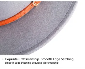 Detail showing the gray wool felt fedora texture with orange band and metal buckle