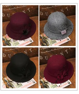 Dettaglio dei cappelli cloche retrò con fiori e perline in bordeaux, grigio e nero