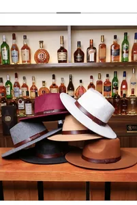 Close-up of wide brim wool fedora hats with leather bands and metallic Lhasa emblem