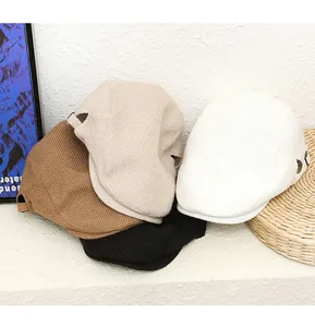 Close-up of assorted breathable mesh newsboy caps with adjustable side buckles