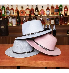 Detailed texture of felt fedora hats in grey and pink with vintage leather buckle bands