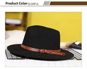 Detailed view of black wool fedora with brown leather band and metal buckle accents