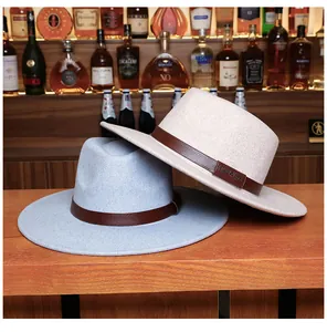 Detail view of khaki and blue fedora hats with leather bands on a vintage bar counter