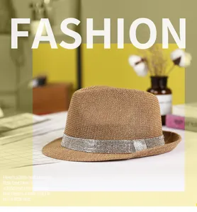 Detail of straw fedora hat featuring a sparkling rhinestone band and woven texture