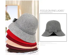 Detail view of colorful wool felt cloche hats featuring decorative bows and elegant textures