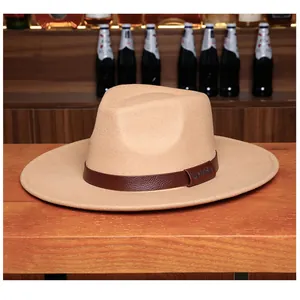 Detail of khaki wide brim wool fedora hat featuring brown leather band with LHASA embossing
