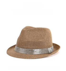 Close-up of brown woven fedora hat featuring a sparkling silver rhinestone headband decoration