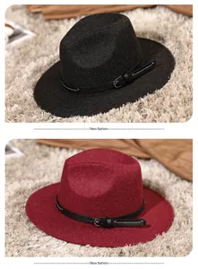Detail view of two-tone wool fedora hats with leather belts and metal buckles