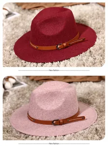 Detail of wool fedora hats in burgundy and pink with leather decorative straps