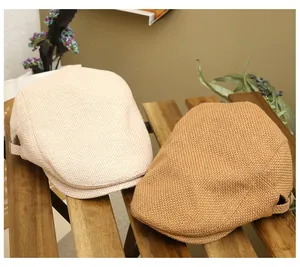 Detail view of woven vintage flat caps in beige and tan on a rustic wooden bench