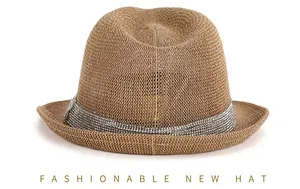 Detail of a brown straw fedora featuring a shiny silver rhinestone decorative band