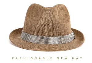 Detail of brown straw fedora hat featuring a wide silver rhinestone decorative band