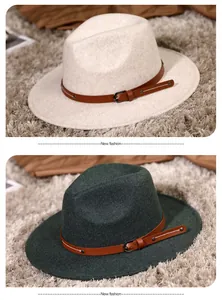 Close-up of wool fedora hat featuring brown leather strap with metal buckle and rivets