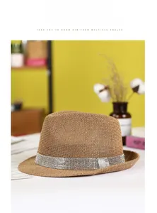 Close-up of brown straw fedora featuring a wide silver rhinestone decorative band