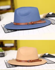 Detail of blue and camel wool fedora hats with faux leather buckled decorative bands