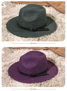 Close-up of wool fedora hats in purple and dark green with leather belts and buckles