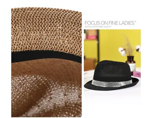 Detail of woven straw fedora featuring sparkling rhinestone band and premium texture