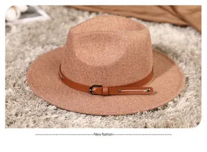 Close-up of caramel felt fedora hat featuring a leather strap with metallic buckle detail