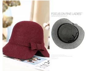 Detail of wool cloche hat with a bow, showing wine red felt texture and adjustable lining