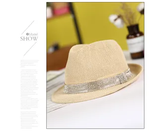 Detail view of beige woven fedora featuring a luxury rhinestone band and fine craftsmanship