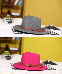 Detail of wool fedora hats in grey and magenta featuring stylish brown leather bands