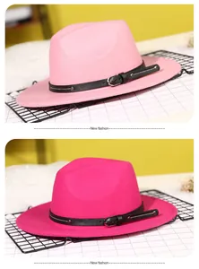 Detail of pink and magenta wool fedora hats with stylish thin black buckle leather bands