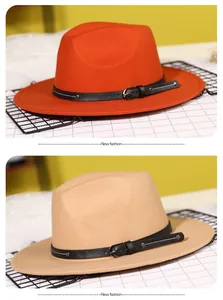 Close-up of orange and khaki wool felt fedora hats with black leather studded bands