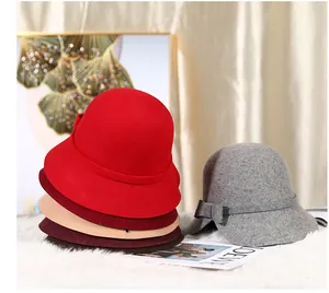 Close-up of elegant wool felt cloche hats with bow detail in various seasonal colors