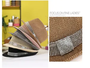 Detail of woven straw fedora hats with sparkling rhinestone decorative bands and buckles
