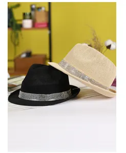 Detail of straw fedora hats featuring shimmering rhinestone bands in black and beige