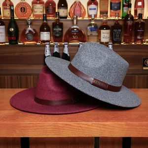 Classic dual-tone wool fedora hats with leather LHASA bands on a rustic bar counter