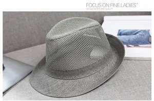 Close-up of grey breathable mesh crown and tightly woven brim on a summer fedora