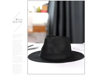 Classic black linen panama fedora hat with a stylish wide ribbon on white surface