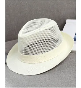 Detailed close-up of white breathable mesh weave and textured brim on summer fedora hat