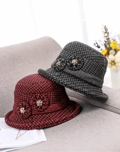 Detailed knit texture of wool blend bucket hats with fabric flowers and metal buckles