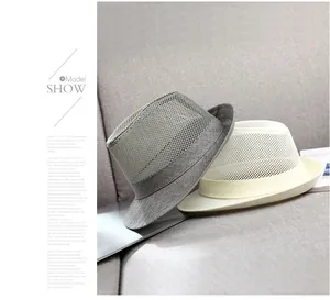 Close-up of the breathable hollow mesh texture on gray and beige summer fedora hats