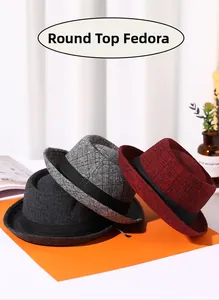 Close-up of three vintage British style fedoras in charcoal black, light grey and wine red