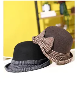 Detail view of foldable wool cloche hats with check patterns and decorative bows
