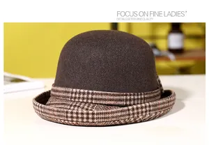 Close-up of a brown wool cloche hat with a stylish houndstooth pattern rim for women