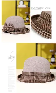 Detailed view of women's grey cloche hat featuring brown houndstooth bow and texture