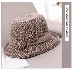 Detailed view of brown houndstooth wool fedora featuring two 3D floral decorations