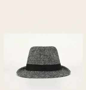 Detail view of the vintage grey plaid pattern and black ribbon band on a British style fedora
