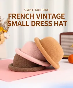 Three classic wool felt cloche hats in brown, pink and camel with retro rolled edges